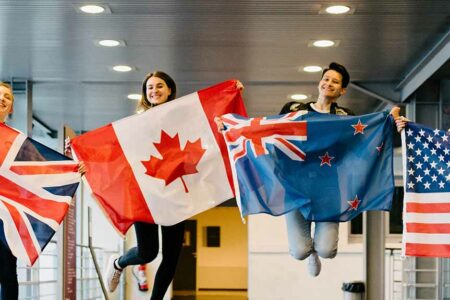 Etudiants sautant avec des drapeaux